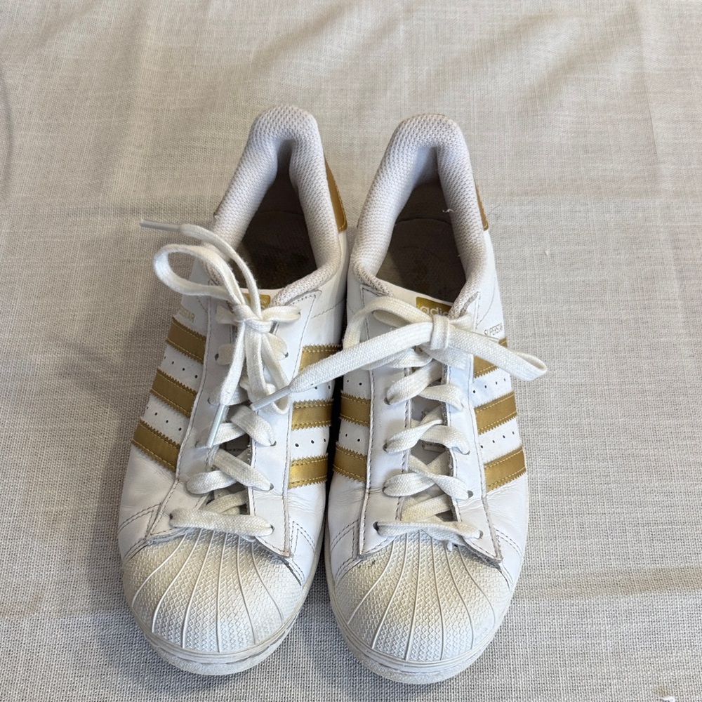 Adidas White Sneakers with Gold Stripes